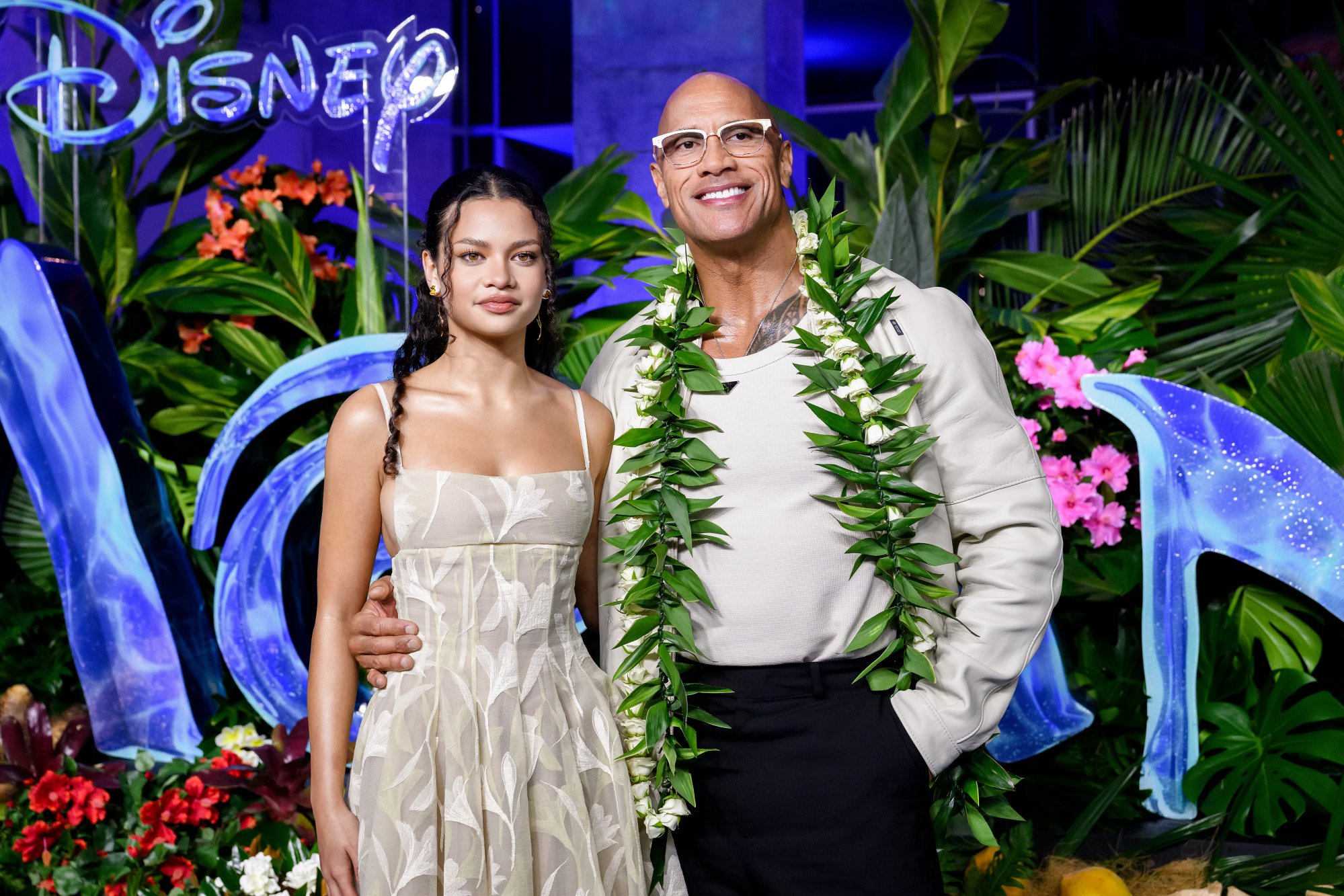 Moana star walks home-town blue carpet with 'The Rock'