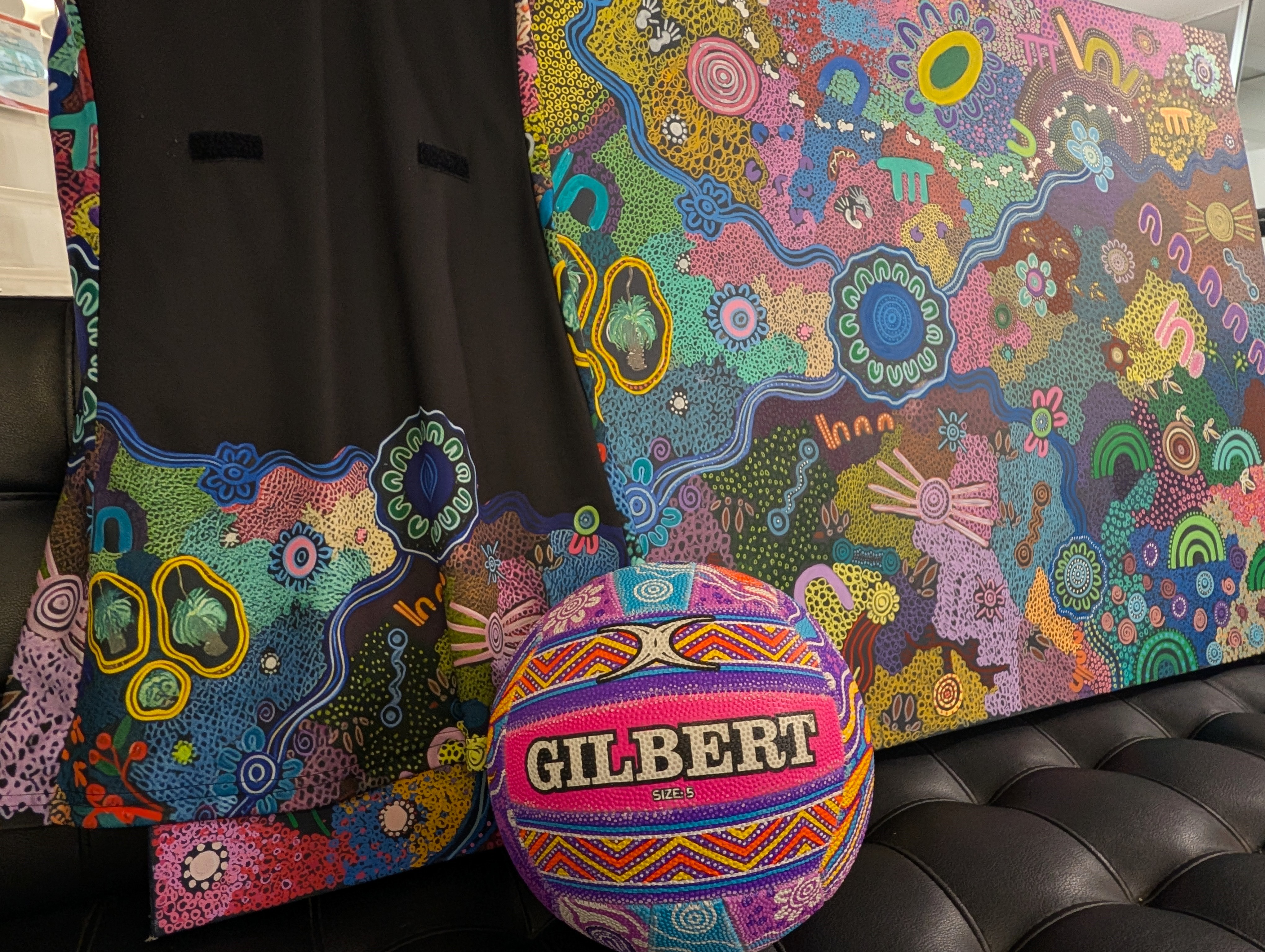 An Old Ways New Ways netball team uniform and the artwork that inspired it. Image: Giovanni Torre.