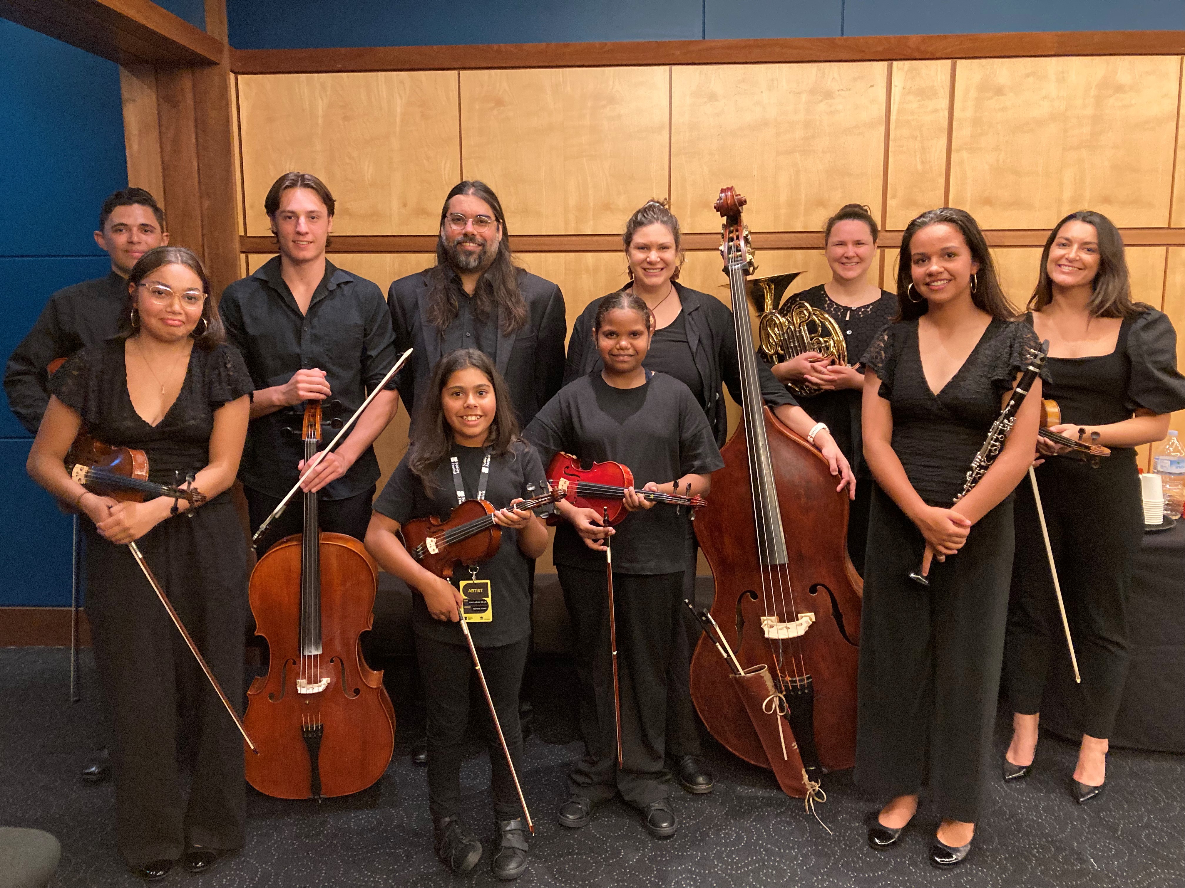 Sandra (centre, in front of woman with double bass) with other One Day in January participants and mentors.