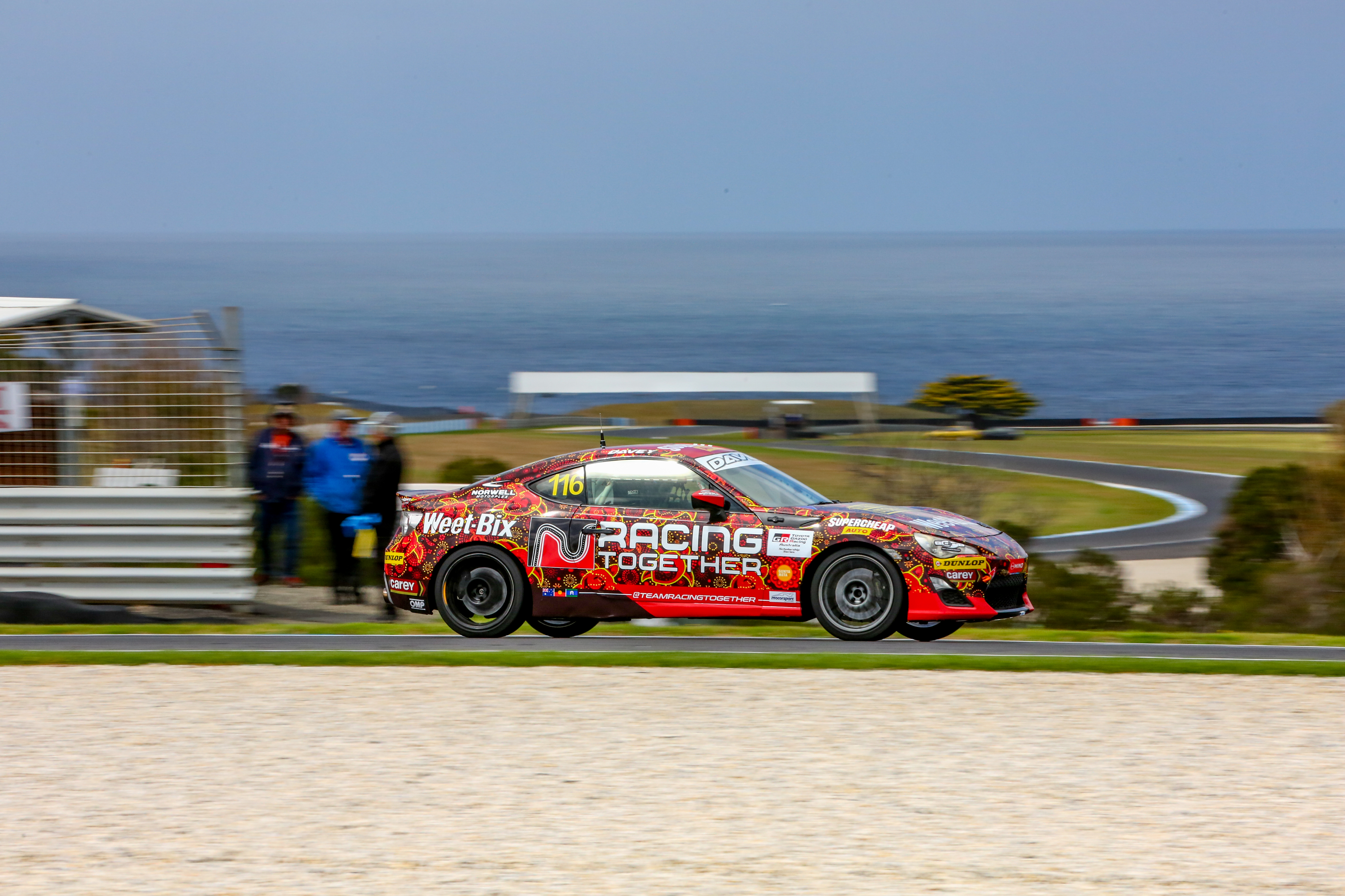 Racing Together car at Phillip Island, ocean in background